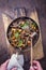 Preparing fresh fried veal liver with chanterelle in sauce in a rustic casserole