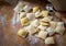 Preparing fresh natural ravioli on wooden kitchen table