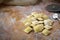 Preparing fresh natural ravioli on wooden kitchen table