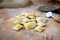 Preparing fresh natural ravioli on wooden kitchen table