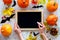 Preparing for halloween. Black desk for notes among pumpkins and bats on grey background top view mockup