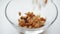 Preparing a healthy Breakfast. he pours a close-up of oatmeal muesli.