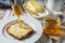 Preparing a healthy breakfast with a toast with butter and pure organic honey from bees