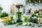 preparing healthy green detox smoothie with blender from vegetables and fruits