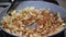 Preparing homemade caramelized pear on frying pan with cinnamon powder. Stirring pear on frying pan.