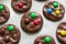 Preparing homemade chocolate cookies decorated with colored candy drops