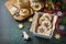 Preparing a homemade sweet present. Linzer Christmas or New Year cookies filled with peanut butter on a dark stone tabletop. Copy