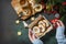 Preparing a homemade sweet present. Linzer Christmas or New Year cookies filled with peanut butter on a dark stone tabletop. Top