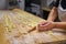 Preparing Italian Stuffed Tortelli on a Long Wooden Table