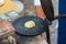 Preparing Little Crepe on Circular Cooking Plate