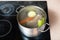 Preparing meat broth in stockpot on ceramic cooker