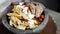 Preparing a mixed molcajete, different meats, fresh cheese and roasted tomatoes with chili served in volcanic stone.