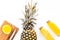 Preparing pineapple juice. Cut pineapple with a knife on white background top view