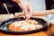 Preparing pizza. Cooks hands and table close-up.