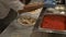 Preparing Pizza Margherita on a marble countertop.