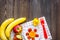 Preparing quick lunch for schoolchild. Fruits on dark wooden table background top view copyspace