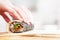 Preparing, rolling sushi. Salmon, avocado, rice and chopsticks on wooden table.