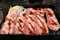 preparing sliced meat on black tray for shabu