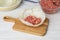 Preparing stuffed cabbage roll on white wooden table