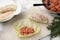 Preparing stuffed cabbage rolls on white marble table, flat lay