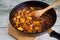 Preparing thanksgiving pumpkin pie in a black pan