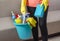 Preparing to clean the house, apartment, a woman holds a bucket with cleaning products and a sponge