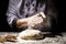 Preparing traditional homemade bread. Close up view of baker kneading dough. Homemade bread. Hands preparing bread dough on wooden