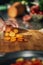 Preparing Vegan Meal -  Chef Cutting Carrot on Wooden Cutting Board