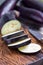 Preparing vegetable dish. Eggplant and eggplant slices on a wooden cutting board and background, vertical