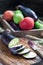 Preparing vegetable dish. Eggplant and eggplant slices on a wooden cutting board, vegetables on background