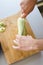 Preparing zuchini hands on the kitchen table close up