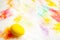 Prepearing for Easter. Painted Yellow color egg on colorful background. copyspace
