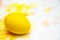 Prepearing for Easter. Painted Yellow color egg on colorful background. copyspace