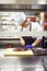 Prepping the perfect piece of beef. chefs preparing a meal service in a professional kitchen.