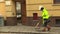 PREROV, CZECH REPUBLIC, NOVEMBER 17, 2017: The woman sweeps and cleanses the sidewalk of the city, very dirty, ugly and