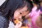 Preschool Asian girl eating Golden thread Foi thong for snack during playing in house. Child eat sweet during the day.