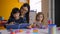 Preschool asian girl reading book with teacher