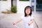 Preschool Asian little child girl make a playful face. Children wrapped up the mouth and  ride a bicycle.