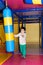 A preschool boy of 4 years old plays with a punching bag for boxing in the playroom, a children& x27;s entertainment center