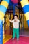 A preschool boy of 4 years old plays with a punching bag for boxing in the playroom, a children& x27;s entertainment center