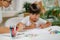 Preschool boy doing school education assessment test. Psychologist asking a questions and preschool boy writing answers
