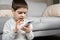 A preschool boy uses a smartphone, plays games on his phone, place for text