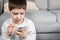 A preschool boy uses a smartphone, plays games on his phone, place for text