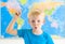 Preschool boy with world map