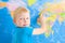 Preschool boy with world map