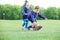 Preschool boys catching pet rabbit in park