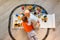 Preschool boys drawing on floor on paper, playing with educational toys - blocks, train, railroad, vehicles at home or daycare.