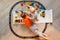 Preschool boys drawing on floor on paper, playing with educational toys - blocks, train, railroad, vehicles at home or daycare.