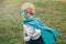 Preschool Caucasian child boy playing superhero in green costume