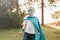 Preschool Caucasian child boy playing superhero in green costume